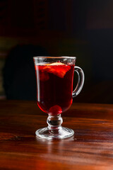 Closeup of mulled wine, in a glass over Traditional Ukrainian tablecloth. Christmas time, winter time.