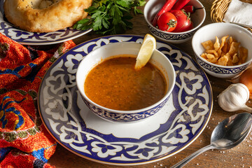 Uzbek lentil and onion soup with lemon and fried pita bread.