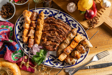 A large set of different types of shish kebab on a traditional Uzbek plate.