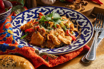 Fried chicken breasts with sweet peppers and cucumbers in soy sauce.