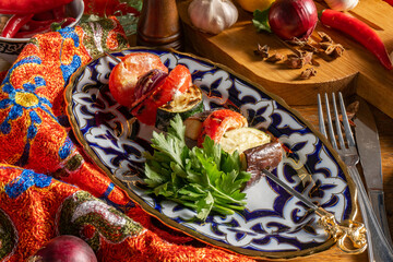 Shish Kebab from grilled vegetables in a plate with a traditional Uzbek ornament