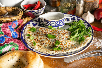 Kutab. Thin flatbread made of unleavened dough with herbs.