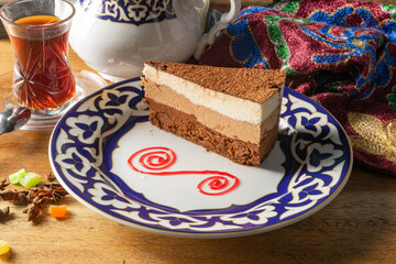 Dessert of mousse sponge cake with black, milk and white chocolate.