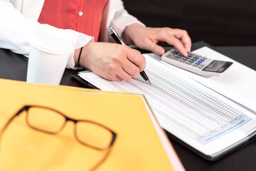 Businesswoman using calculator