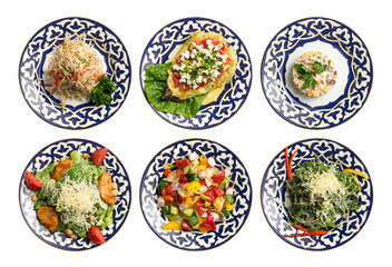 A set of salads and cold appetizers in plates with a traditional Uzbek pattern.