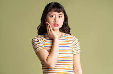 Young beautiful Asian woman posing on background