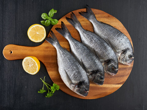 Raw bream on a wooden board