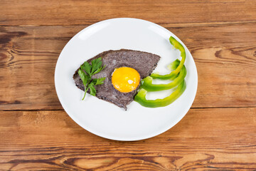 Fried egg with beaten egg white mixed with black olives