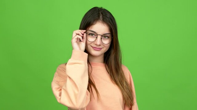 Young caucasian woman with glasses. Portrait over isolated background. Green screen chroma key