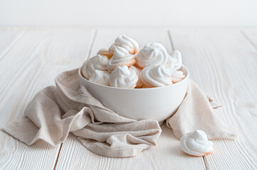 Delicious and crunchy meringue dessert on a white background. Side view.