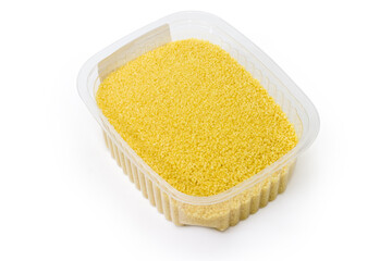 Raw couscous in small plastic container on a white background