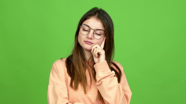 Young caucasian woman with glasses with headache over isolated background. Green screen chroma key