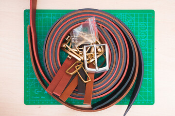 Leather straps lying on a green stand on the table