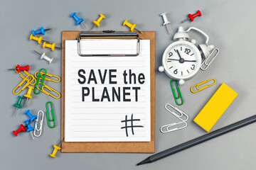 The words Save the Planet written on a white notebook