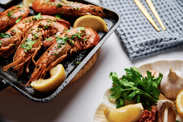Grilled large shrimps with lemon and spices on the grill pan