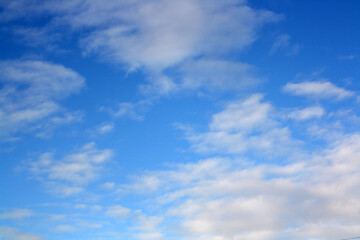 Blue sky with floating white clouds.