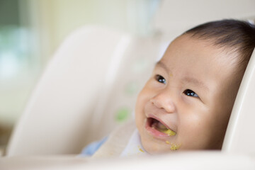 6 months old Asian baby eating food