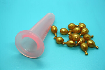 A jar for facial massage and gold capsules with oil.