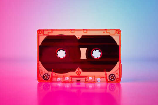 Retro cassette tape on a colorful neon background