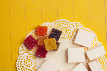 marmalade multicolored candy chocolate sweets dessert on a yellow background