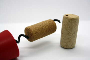 Wine corks and corkscrew isolated on a white background.