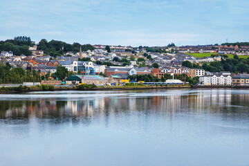 Fototapeta na wymiar Derry, North Ireland. Aerial view of Derry Londonderry city center in Northern Ireland, UK. Sunny day with cloudy sky, city walls and historical buildings