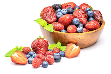 Mixed sweet fresh berries on white background. Ripe strawberry, raspberry, blueberry and mint leaves.