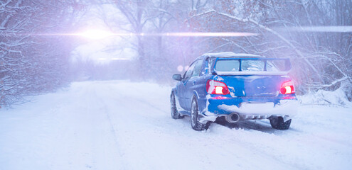 fast blue sport car on winter snowy day, cold season, street road