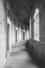 Black and white photo of empty corridor inside ancient roman building