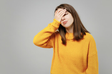 Young excited happy cute indignant confused caucasian woman 20s wearing casual knitted yellow...