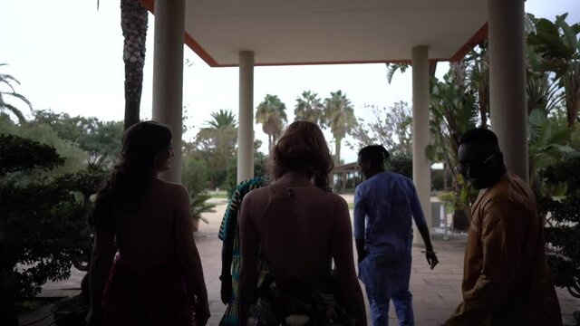 Group of guests attending wedding party, entering hotel lobby
