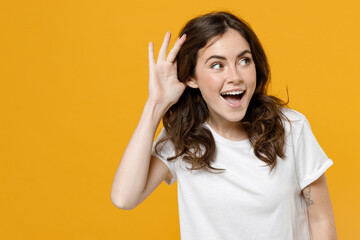 Young european caucasian happy excited curious nosy woman 20s wear white basic casual t-shirt...