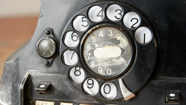 Calling 112 emergency number on old-fashioned rotary phone.