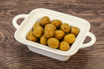 Green pickled olives in the bowl