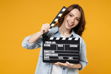 Young smiling happy brunette positive fun woman 20s in stylish denim shirt white t-shirt holding...