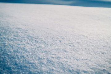snowdrifts in the field, the texture of snow. Background winter January, February. The sun is shining on a winter field. Cold Journey