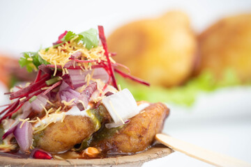 Detailed Coseup Of Chaat Snacks Aloo Tikki Also Known As Alu Ki Tikkia Boiled Mashed Potato Cutlet Or Patties Served With Imli Dhaniya Pudina Green Chutney Sauce Dahi Anar Chukandar Onions  Sev Bhujia