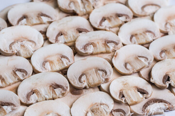 Young mushrooms champignons, sliced into plates, close-up, background, selective focus