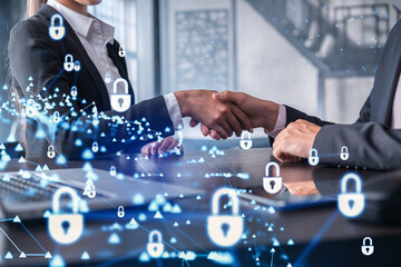 Handshake of two businesspeople who are negotiated the project to protect cyber security of...