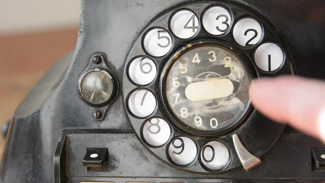 Dailing 211 on an old-fashioned rotary phone  to get information about health or in case of emergency