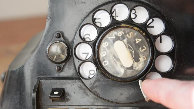 Dailing 311 on an old-fashioned rotary phone 
