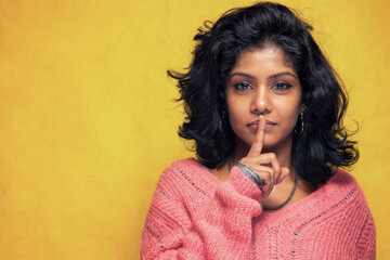 Fototapeta na wymiar Pretty Sri Lanka young woman posing silence with yellow bright background