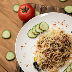 Spaghetti or pasta, close up. Simple rustic food. Hearty lunch. Serving plate of Italian traditional food. Top view. Square format. Template for restaurant menu design and social media publications.