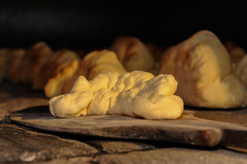 The bread of Matera, Pane di Matera, has the shape of a croissant and is produced with the exclusive use of durum wheat semolina. cooking in the large wood oven
