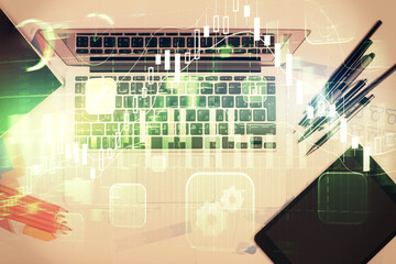 Multi exposure of forex chart drawing over table background with computer. Concept of financial research and analysis. Top view.