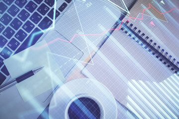 Stock market graph and top view computer on the table background. Double exposure. Concept of financial education.