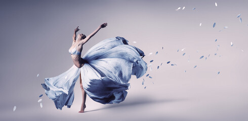 Woman dancing in flowing blue dress