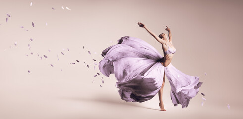 Woman dancing in flowing purple dress