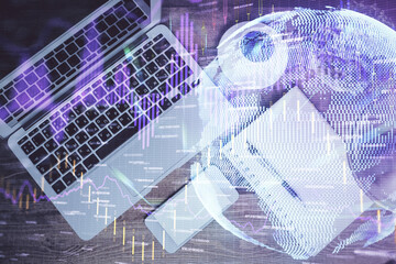 Financial market graph and top view computer on the desktop background. Double exposure. Investment concept.