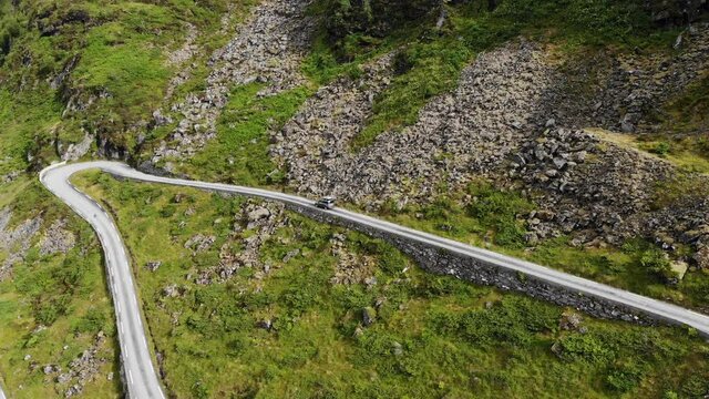 Car driving on Norway winding mountain road. Landscape of Hoddevik in Stadlandet peninsula, Norway.
